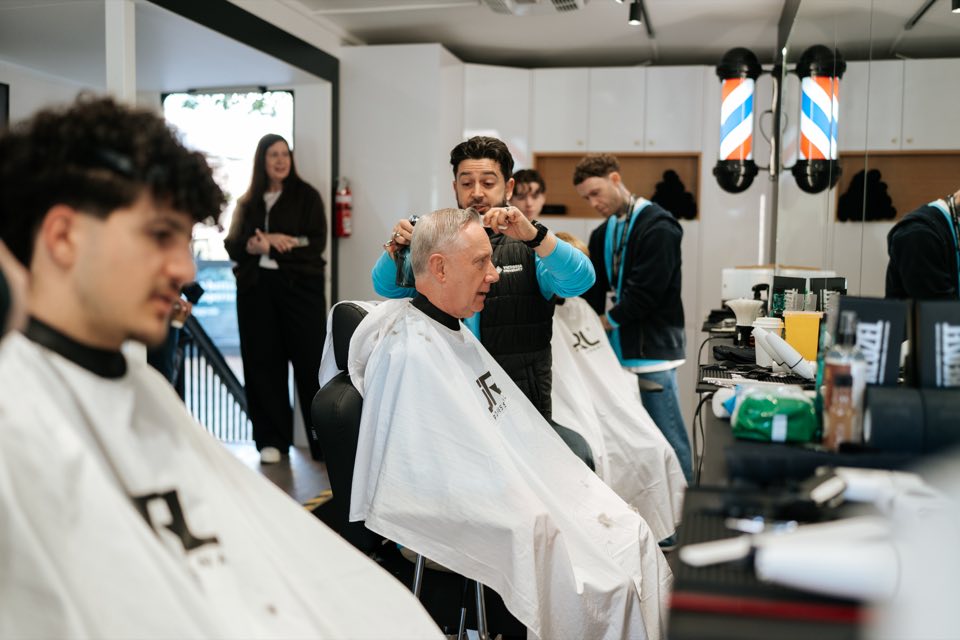 A VU barbering student cuts a visitor’s hair in the training salon.