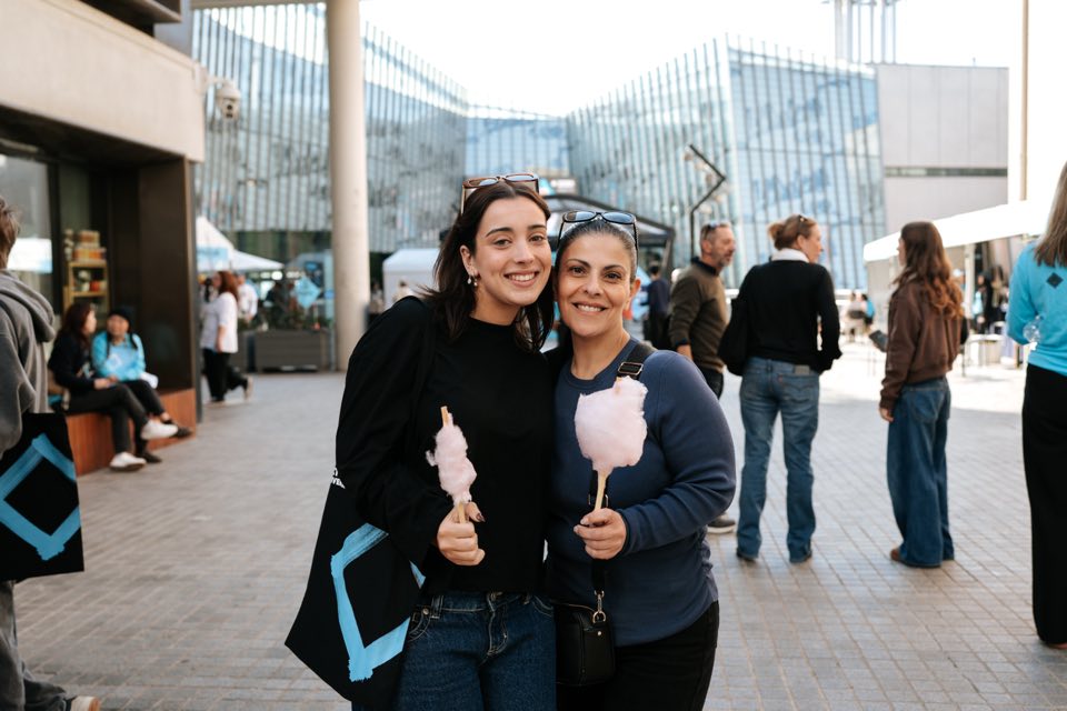 Two visitors hold fairy floss on the Footscray Park forecourt.